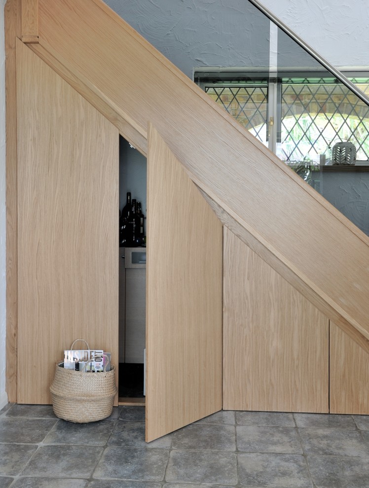 Photo of a mid-sized contemporary glass curved staircase in Other with wood risers and metal railing.