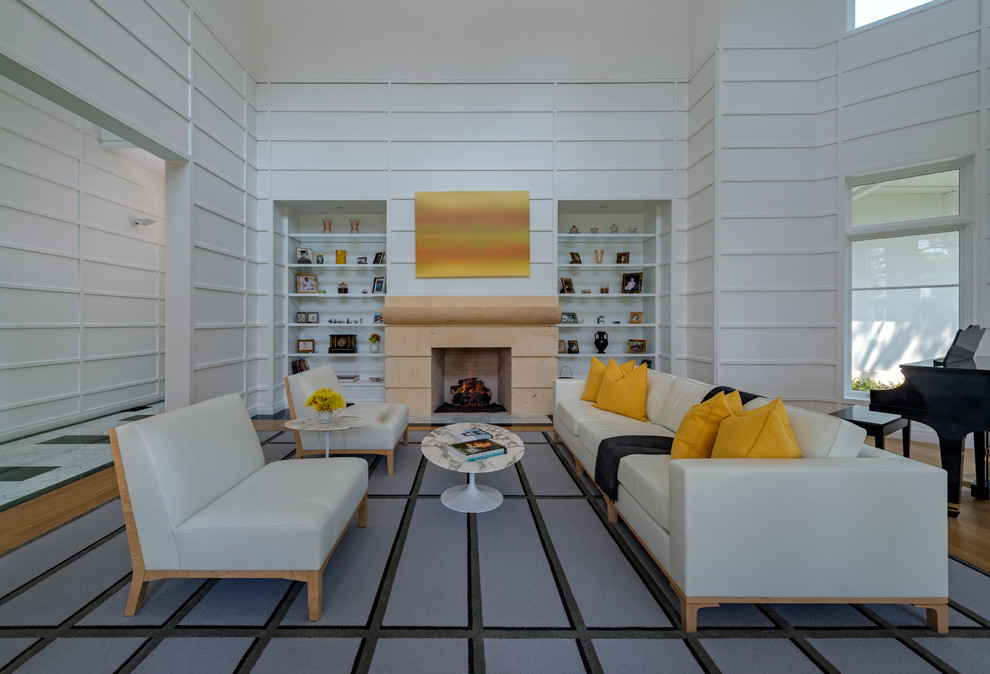 This is an example of a mid-sized modern formal enclosed living room in Dallas with white walls, light hardwood floors, a standard fireplace, a stone fireplace surround and a freestanding tv.