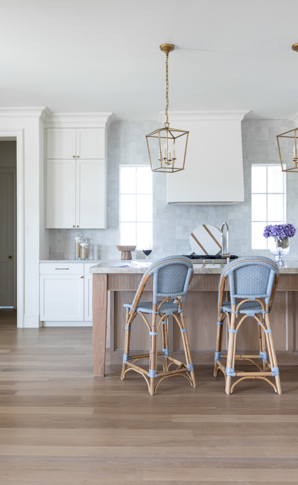 Kitchen - huge transitional light wood floor kitchen idea in Dallas with shaker cabinets, white cabinets, quartzite countertops, stainless steel appliances, an island and beige countertops