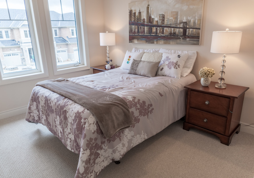 This is an example of a small contemporary guest bedroom in Toronto with white walls, carpet and beige floor.