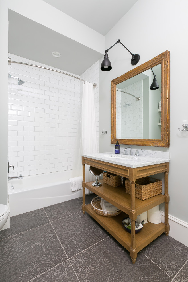 Inspiration for a coastal white tile and subway tile gray floor and single-sink alcove bathtub remodel in Charleston with open cabinets, medium tone wood cabinets, gray walls, an undermount sink, white countertops and a freestanding vanity