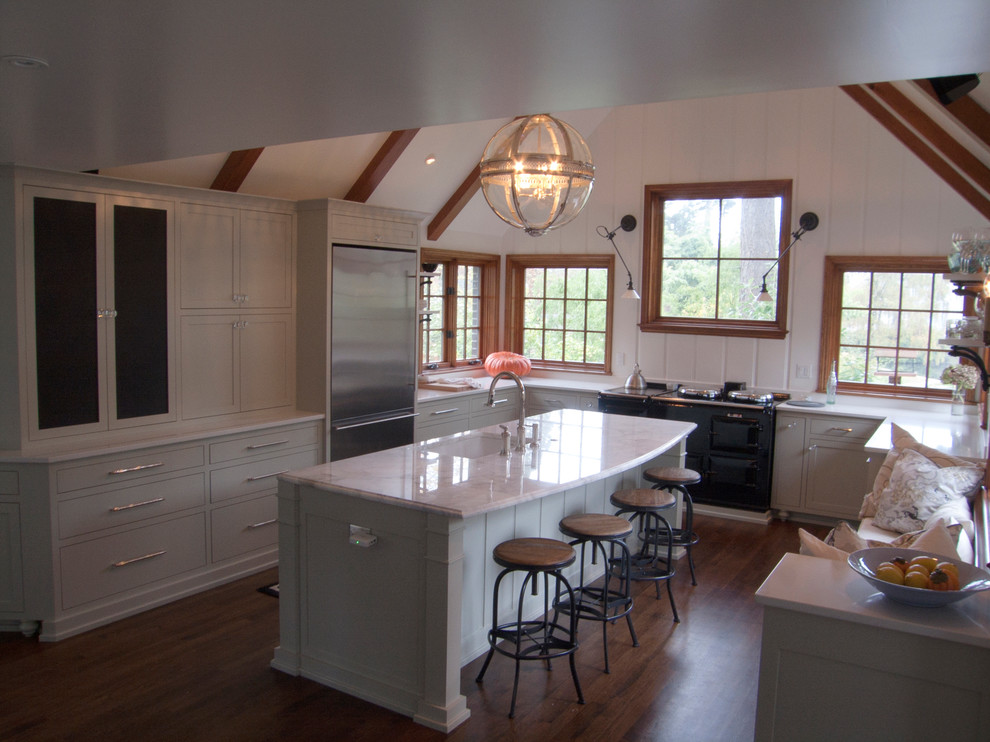 Photo of a traditional u-shaped kitchen in Portland with an undermount sink, white cabinets and marble benchtops.