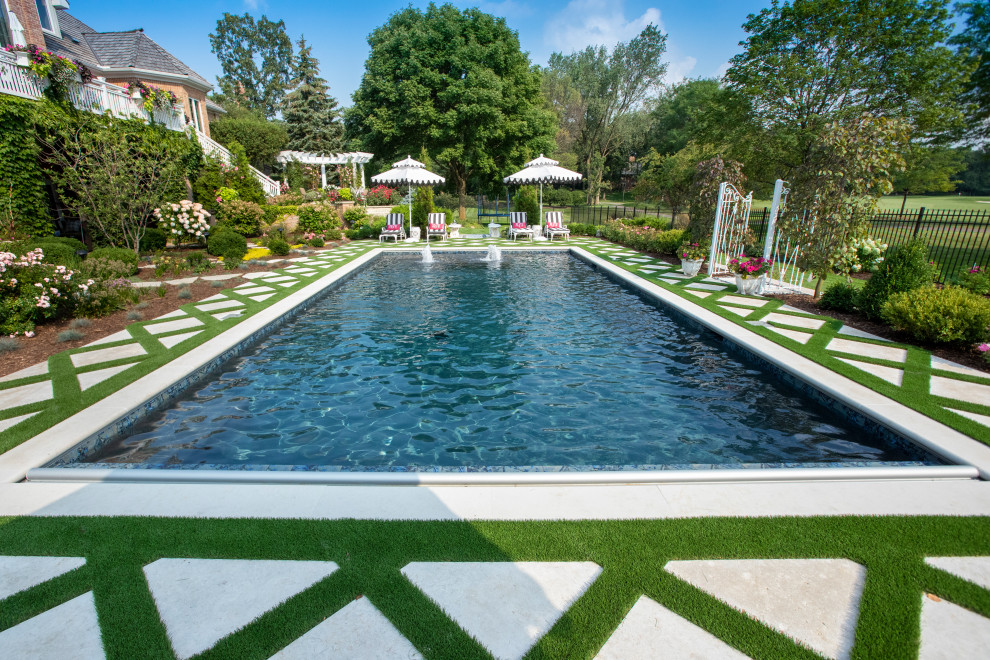 Mid-sized elegant backyard stone and rectangular lap pool landscaping photo in Chicago