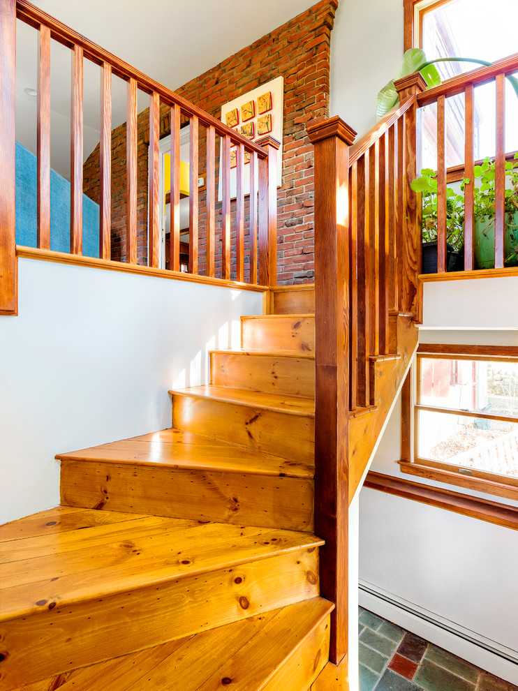 Photo of a mid-sized traditional wood curved staircase in Boston with wood risers and wood railing.