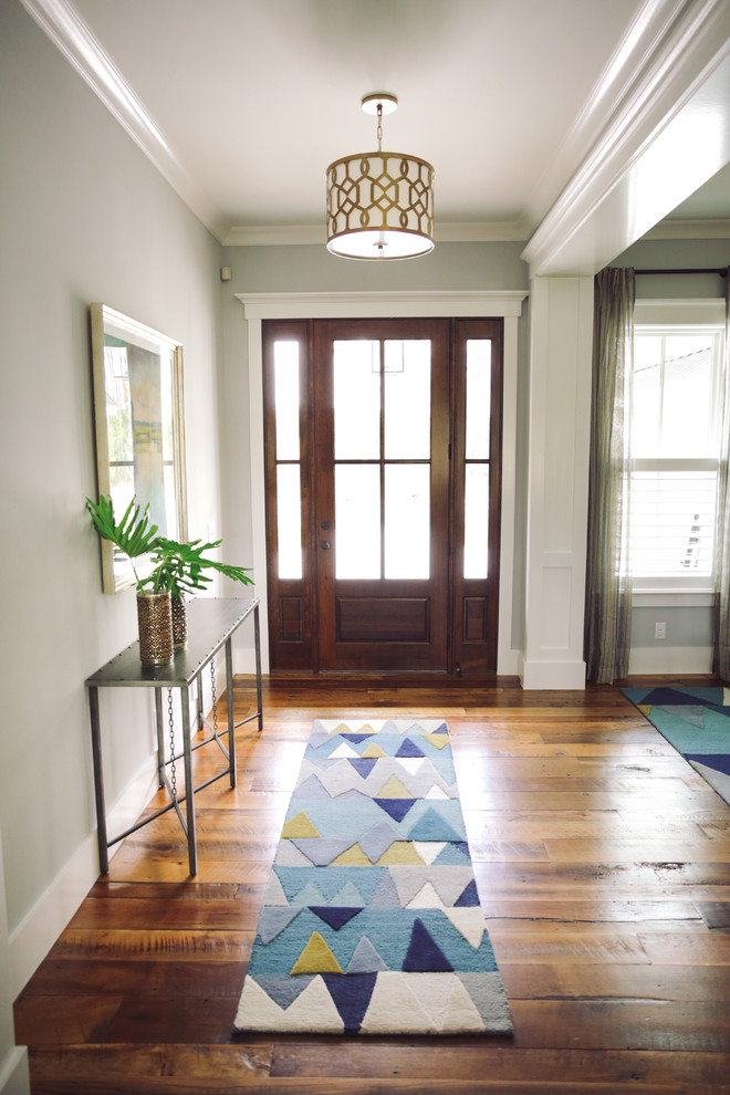 Photo of a transitional foyer in Charleston with grey walls, medium hardwood floors, a single front door, a dark wood front door and brown floor.