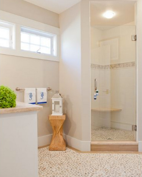 Photo of a mid-sized beach style 3/4 bathroom in Boston with shaker cabinets, white cabinets, an alcove shower, multi-coloured tile, solid surface benchtops, subway tile, beige walls, mosaic tile floors and an undermount sink.