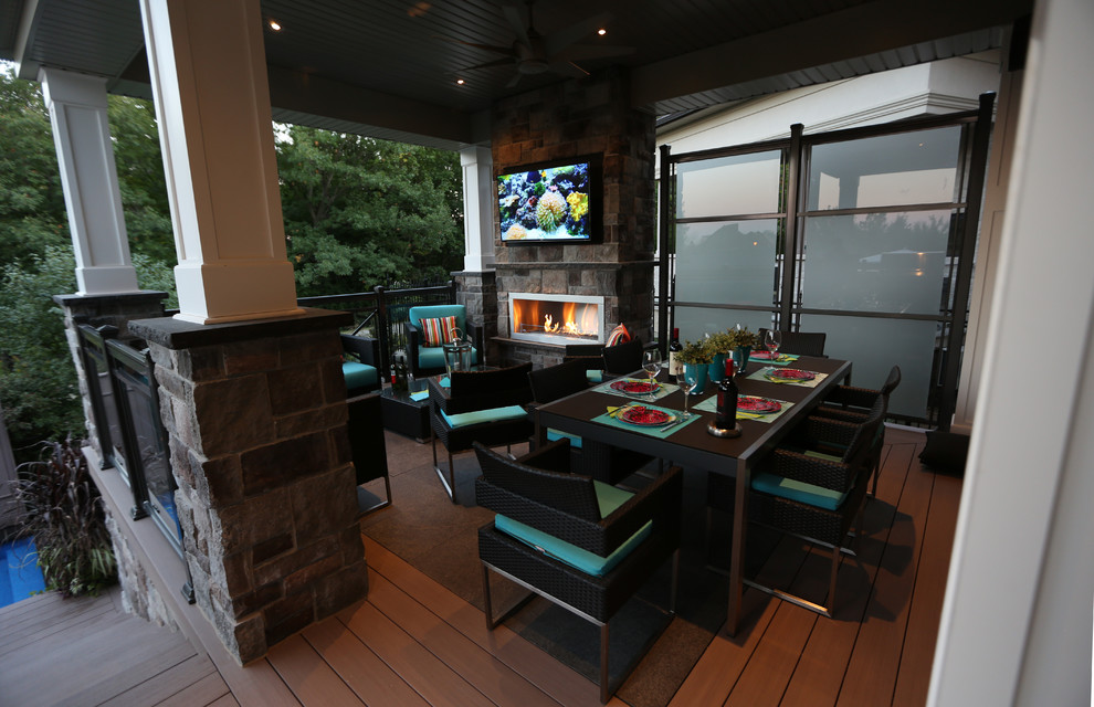 Inspiration for a transitional backyard deck remodel in Toronto with a roof extension