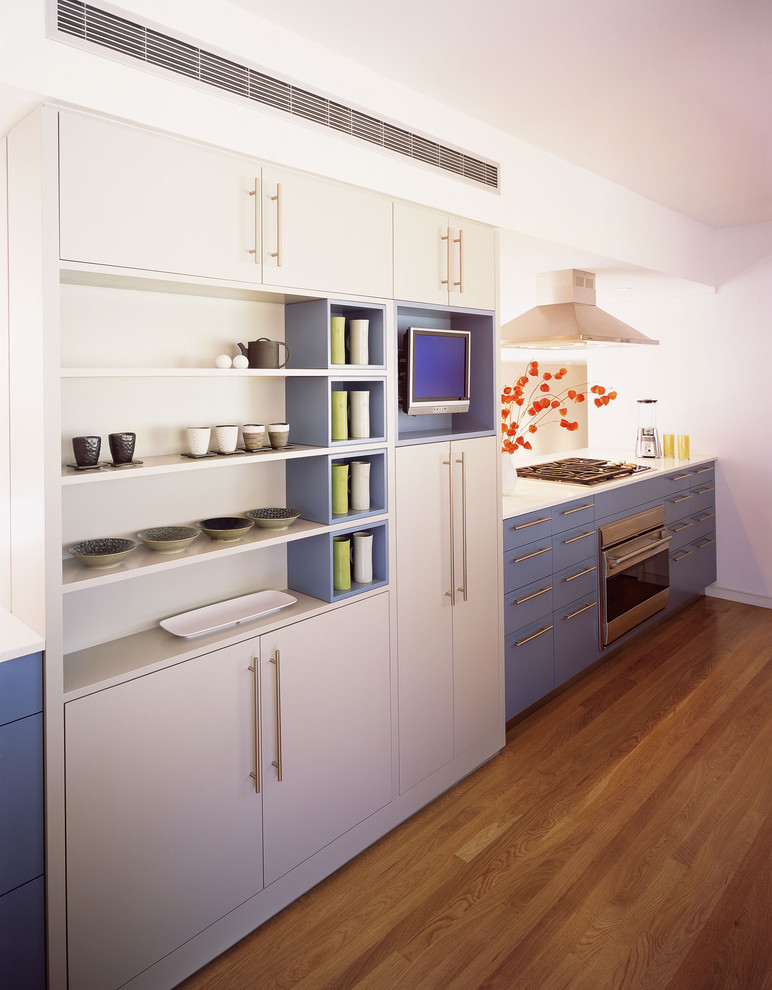 Design ideas for a mid-sized contemporary galley eat-in kitchen in San Francisco with stainless steel appliances, a single-bowl sink, flat-panel cabinets, blue cabinets, quartz benchtops, light hardwood floors and no island.