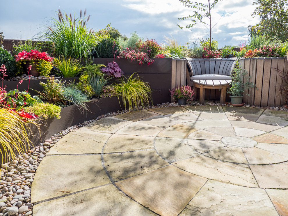 Photo of a small traditional patio in Essex with concrete pavers and no cover.