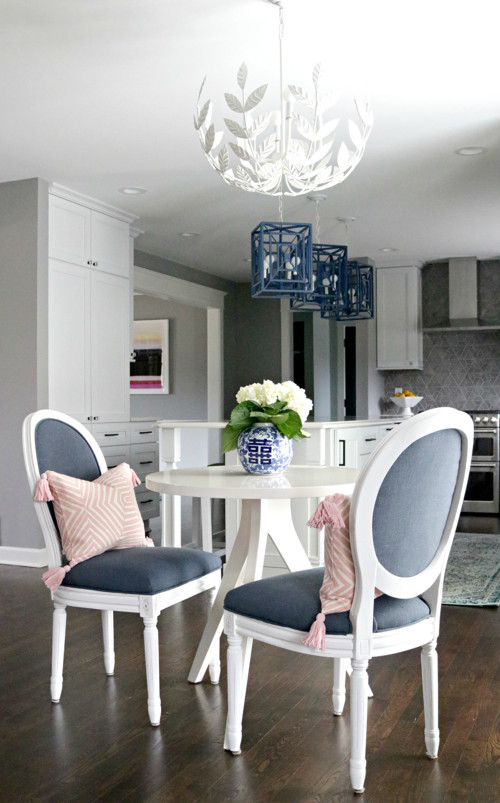 Transitional l-shaped kitchen photo in Milwaukee with white cabinets, quartzite countertops, gray backsplash, ceramic backsplash, stainless steel appliances, an island and white countertops