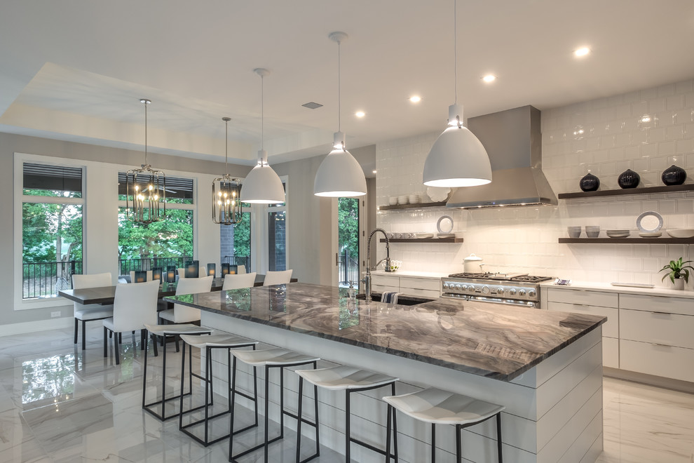 Design ideas for a large modern l-shaped open plan kitchen in Other with an undermount sink, flat-panel cabinets, white cabinets, white splashback, ceramic splashback, stainless steel appliances, ceramic floors, with island, white benchtop, white floor and quartzite benchtops.