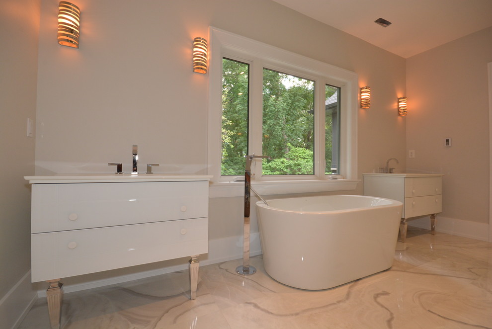 Inspiration for a large contemporary master bathroom in Toronto with an undermount sink, flat-panel cabinets, white cabinets, solid surface benchtops, a freestanding tub, gray tile, terra-cotta tile and marble floors.