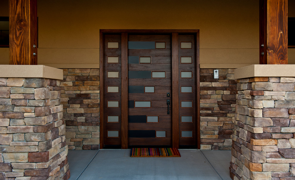 Large contemporary front door in Other with brown walls, concrete floors, a pivot front door and a dark wood front door.