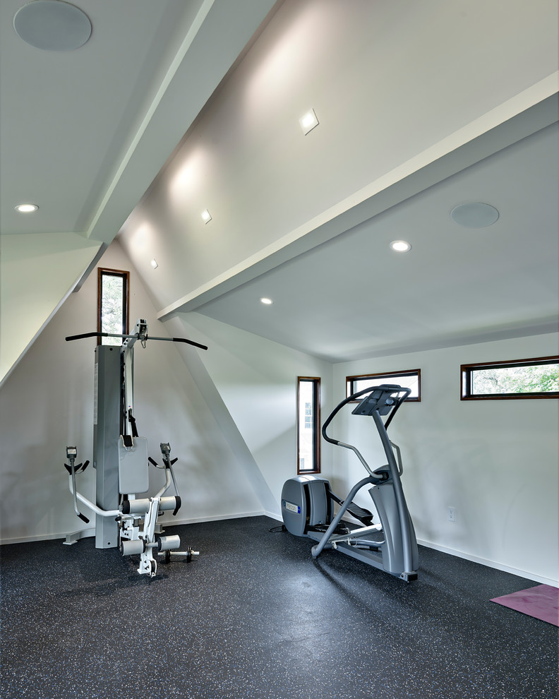 Design ideas for a transitional multipurpose gym in Austin with white walls and black floor.