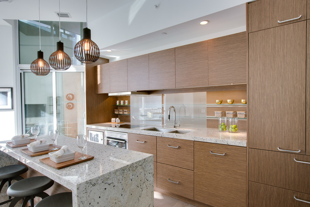 Photo of a mid-sized contemporary galley open plan kitchen in Toronto with an undermount sink, flat-panel cabinets, quartz benchtops, with island, medium wood cabinets, brown splashback, glass sheet splashback, panelled appliances and medium hardwood floors.
