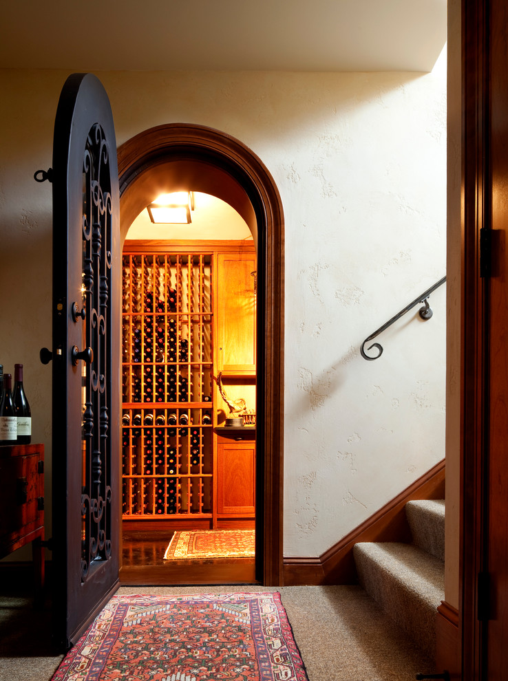 Design ideas for a mid-sized mediterranean wine cellar in Minneapolis with storage racks and carpet.