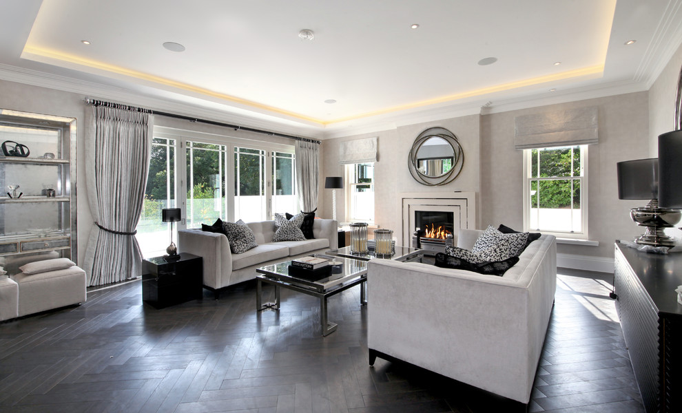 Photo of a mid-sized contemporary enclosed living room in Surrey with grey walls, dark hardwood floors and black floor.