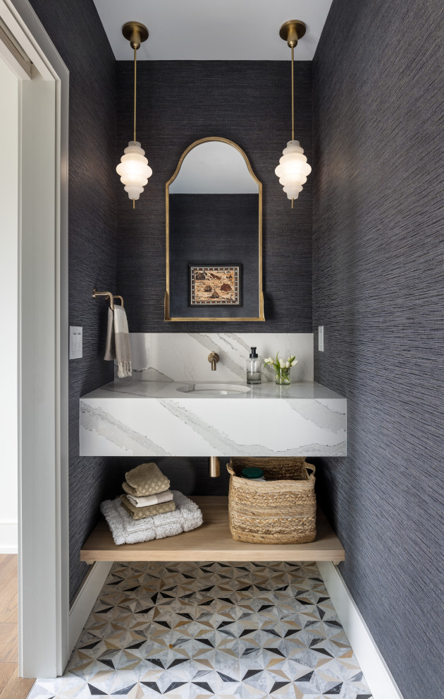 Inspiration for a mid-sized transitional powder room in Detroit with white cabinets, blue walls, porcelain floors, multi-coloured floor, white benchtops, a floating vanity, open cabinets, an undermount sink and wallpaper.