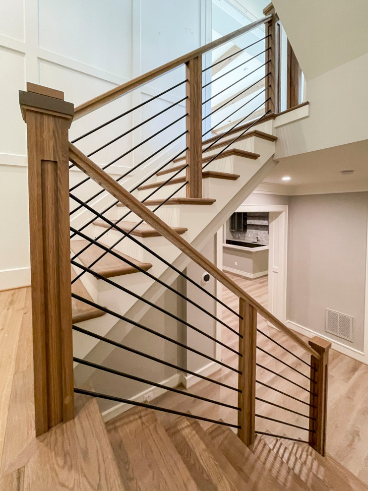 Photo of a large midcentury wood floating mixed railing staircase in DC Metro with wood risers.