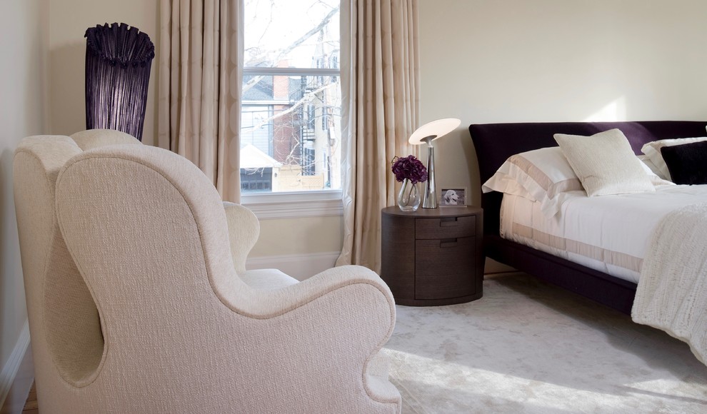 Modern master bedroom in Boston with beige walls, carpet and beige floor.