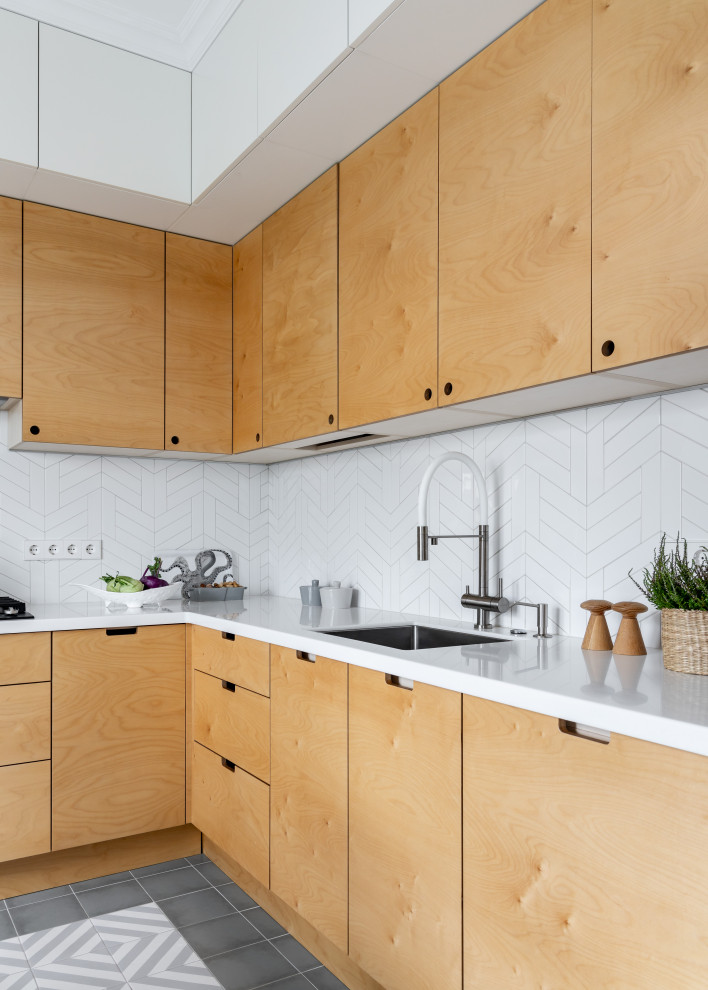 Design ideas for a mid-sized scandinavian l-shaped eat-in kitchen in Saint Petersburg with flat-panel cabinets, yellow cabinets, solid surface benchtops, white splashback, ceramic splashback, ceramic floors, no island, grey floor and white benchtop.