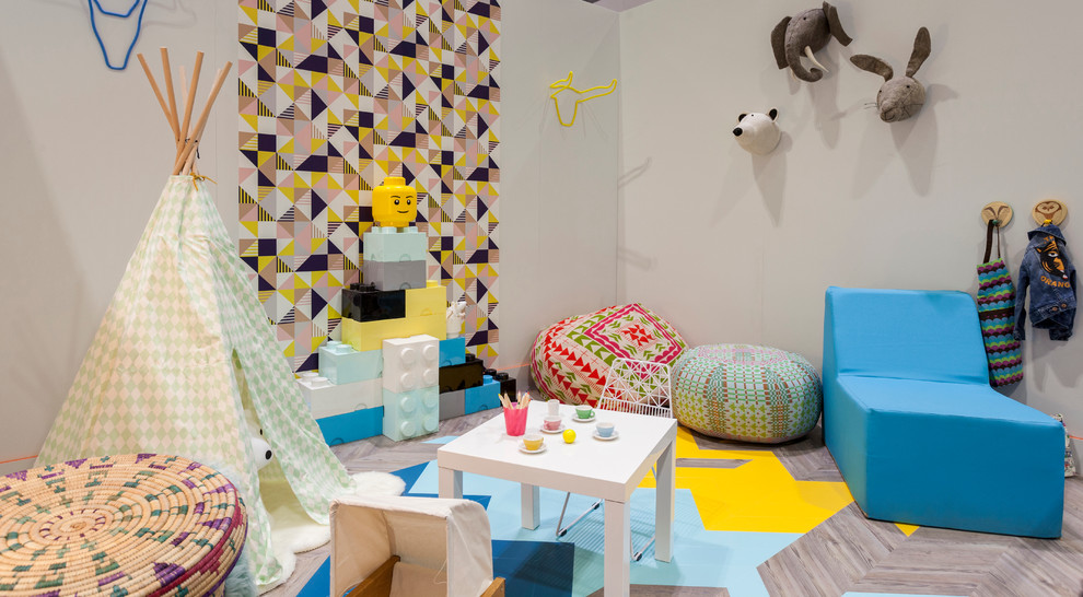Inspiration for an eclectic gender-neutral kids' playroom in London with medium hardwood floors and multi-coloured floor.