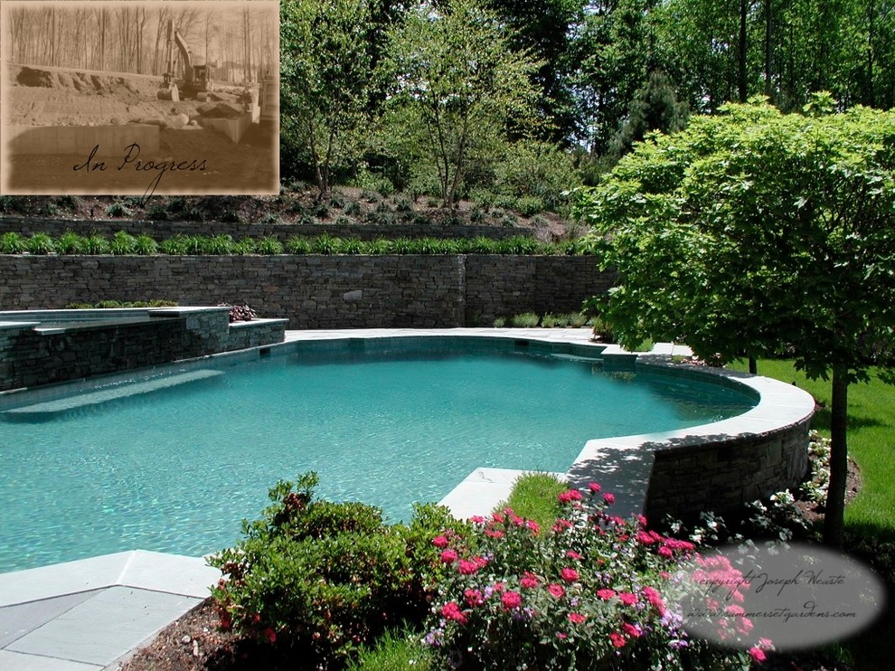 Example of a large classic backyard stone and custom-shaped pool design in New York
