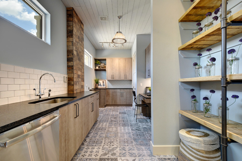 Design ideas for a large industrial galley kitchen pantry in Austin with an undermount sink, flat-panel cabinets, distressed cabinets, granite benchtops, porcelain floors, white splashback, ceramic splashback and stainless steel appliances.