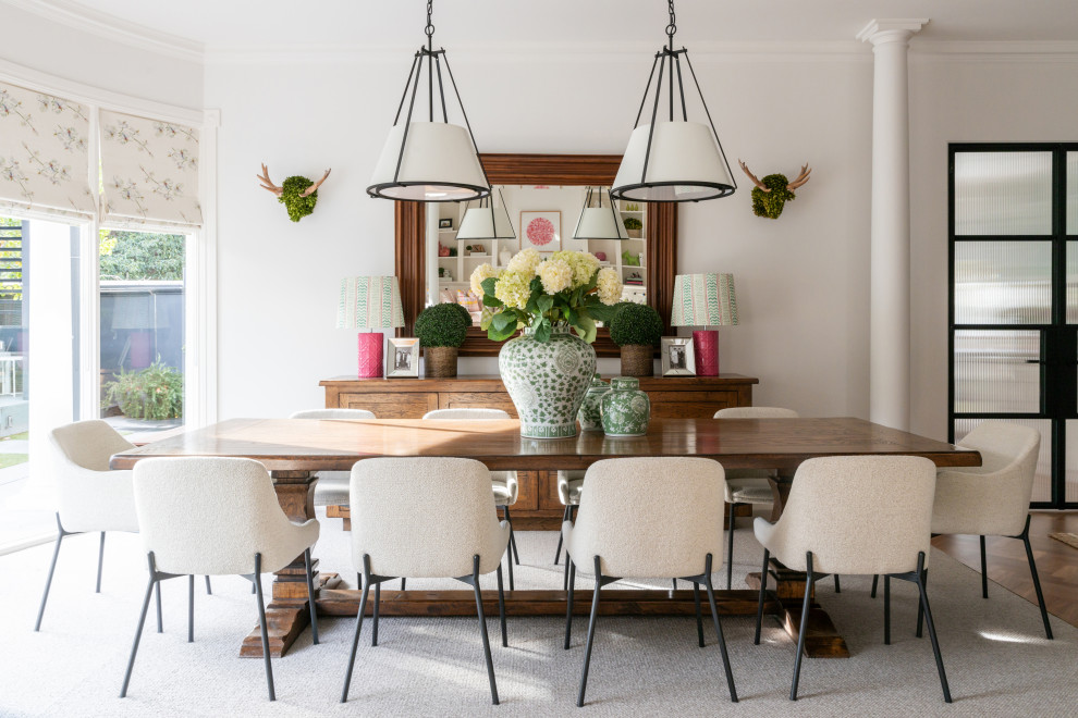 Photo of a mid-sized transitional dining room in Melbourne with carpet, grey walls and grey floor.