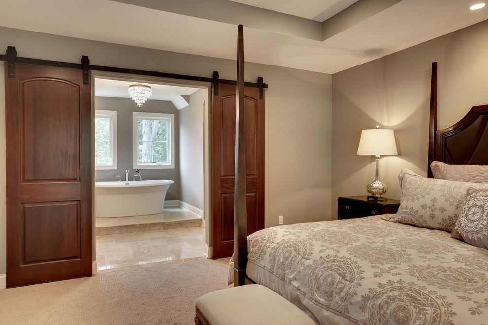Large traditional master bedroom in Minneapolis with grey walls, carpet and no fireplace.