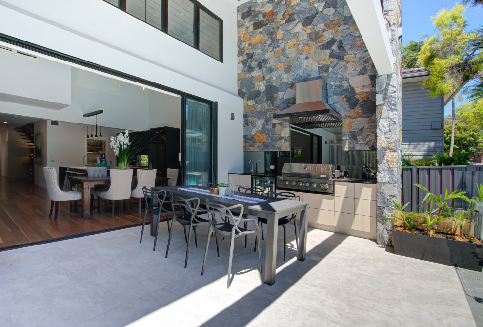Contemporary backyard patio in Brisbane with a roof extension.
