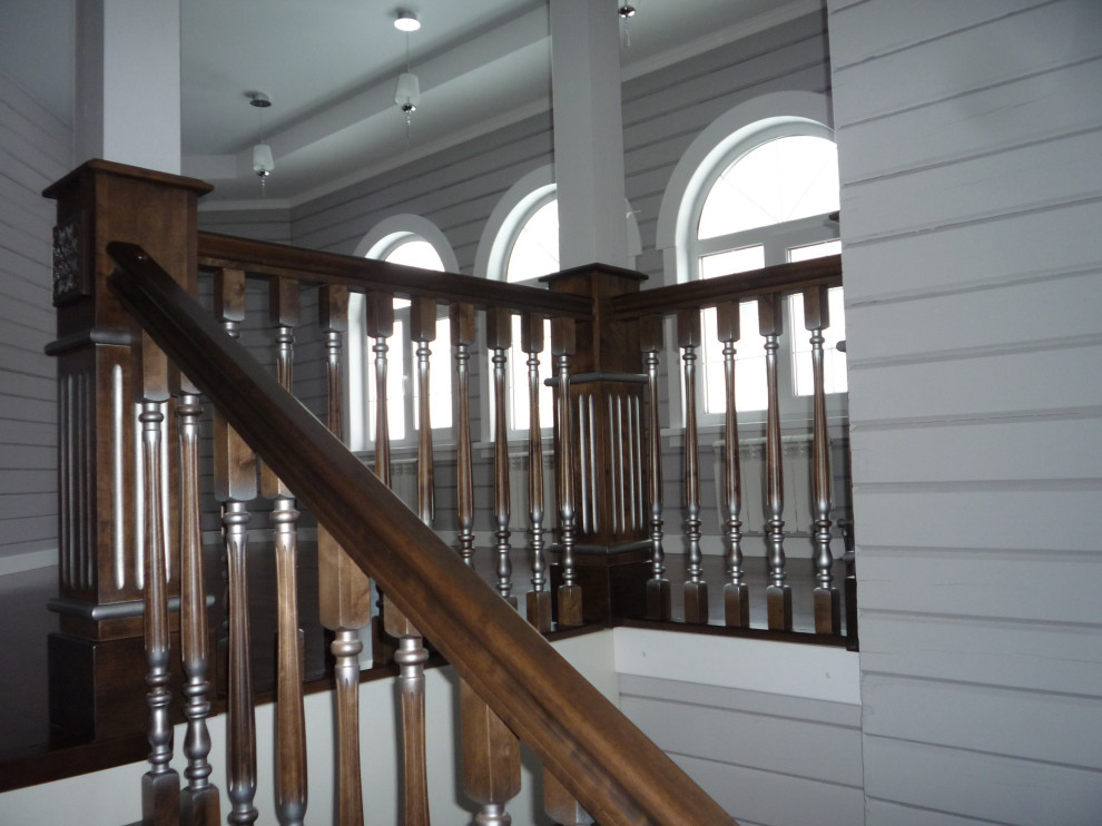 Aménagement d'un escalier campagne en U et bois de taille moyenne avec des marches en bois, des contremarches en bois et un garde-corps en bois.