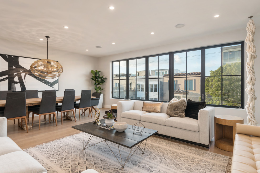 Contemporary formal open concept living room in San Francisco with grey walls, light hardwood floors and beige floor.