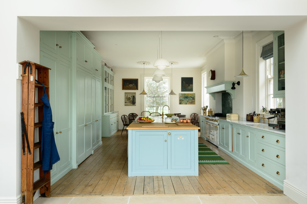 This is an example of an expansive transitional galley eat-in kitchen in Other with a farmhouse sink, shaker cabinets, turquoise cabinets, green splashback, white appliances, with island and grey benchtop.