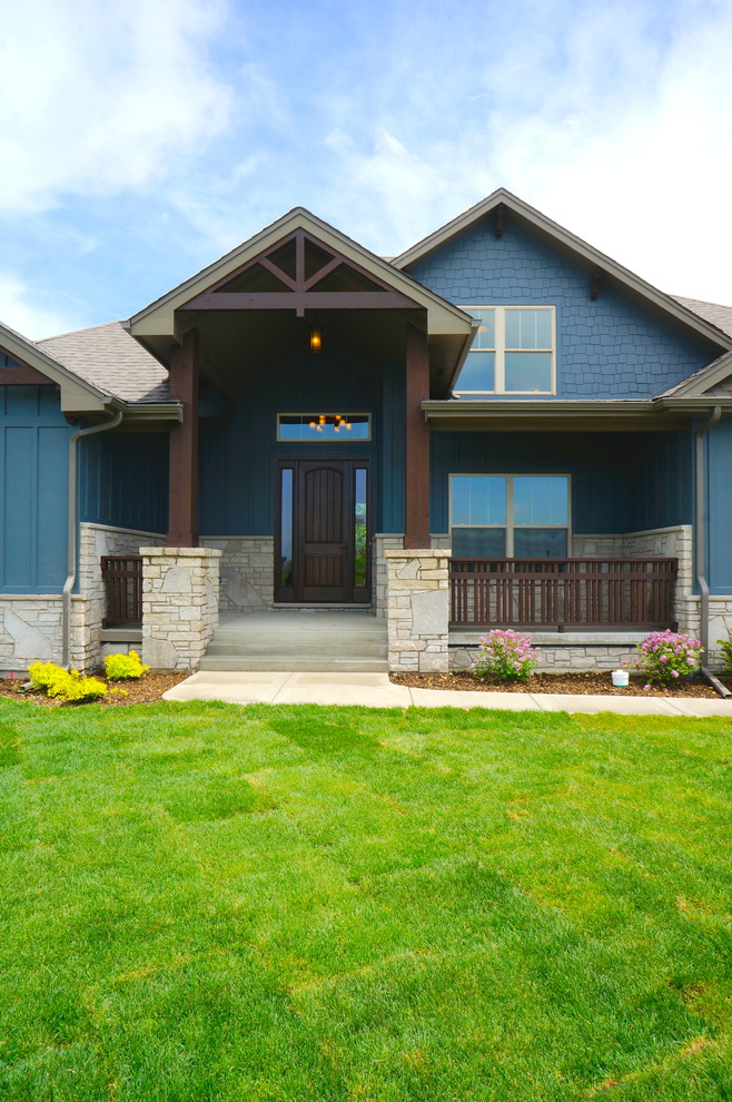 This is an example of a country two-storey blue exterior in Chicago with concrete fiberboard siding.