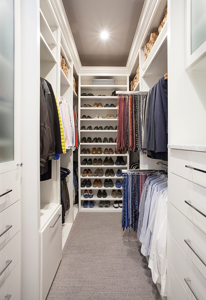Mid-sized transitional gender-neutral walk-in wardrobe in Dallas with flat-panel cabinets, white cabinets, carpet and brown floor.