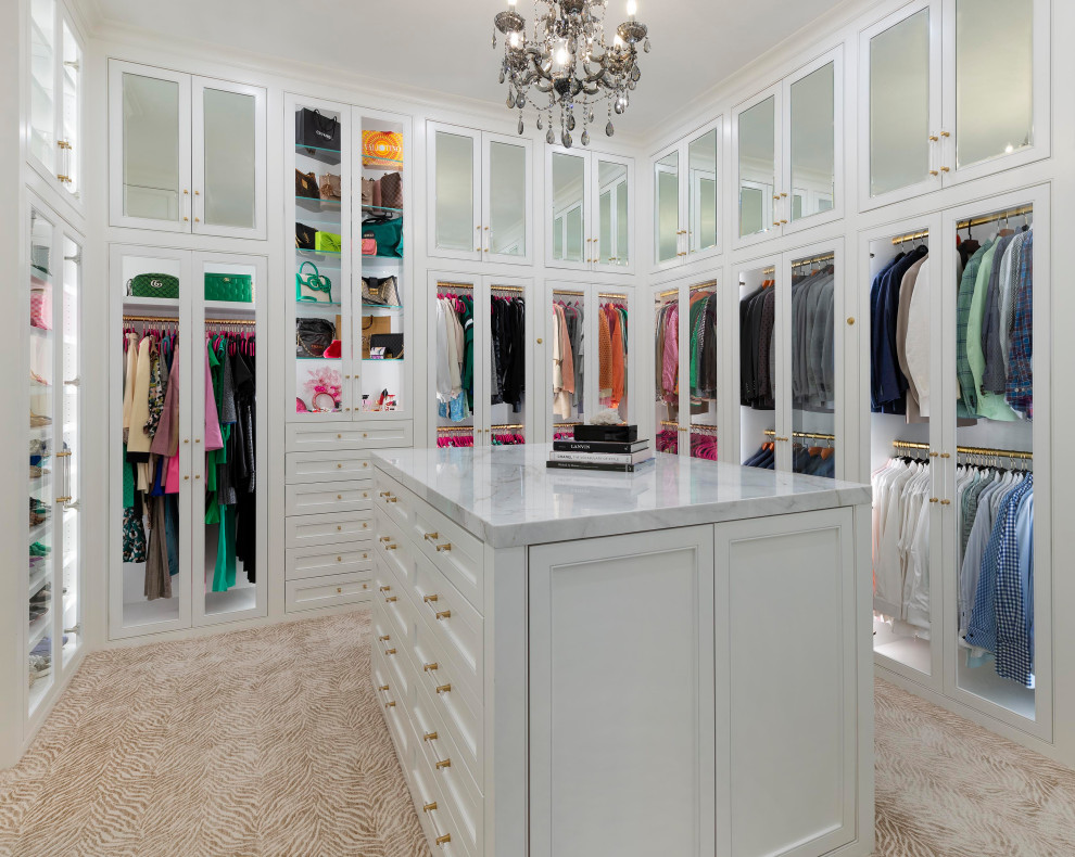 Design ideas for a large transitional gender-neutral walk-in wardrobe in Dallas with white cabinets, carpet, beige floor and glass-front cabinets.
