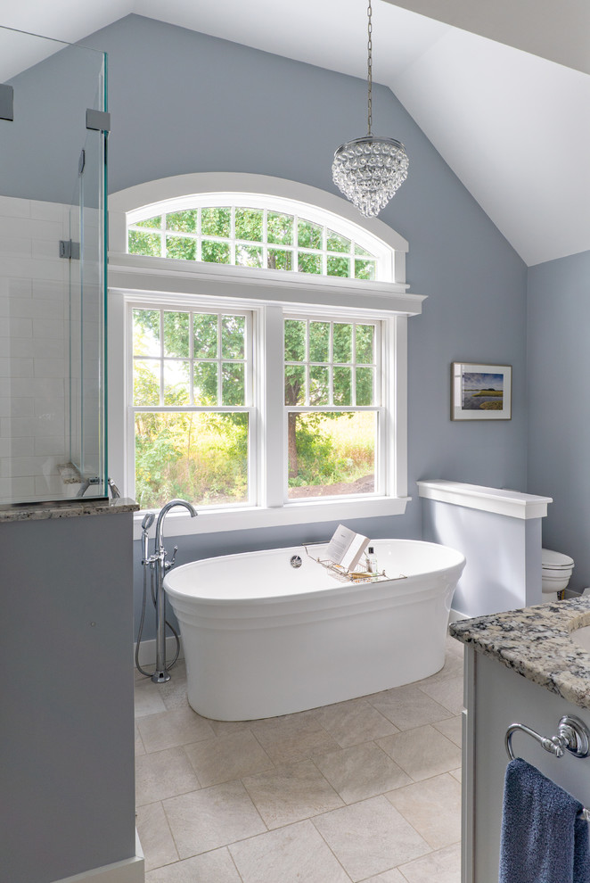 Design ideas for a mid-sized beach style master bathroom in Boston with a freestanding tub, a double shower, white tile, blue walls, porcelain floors, laminate benchtops, a hinged shower door, multi-coloured benchtops, porcelain tile and an undermount sink.