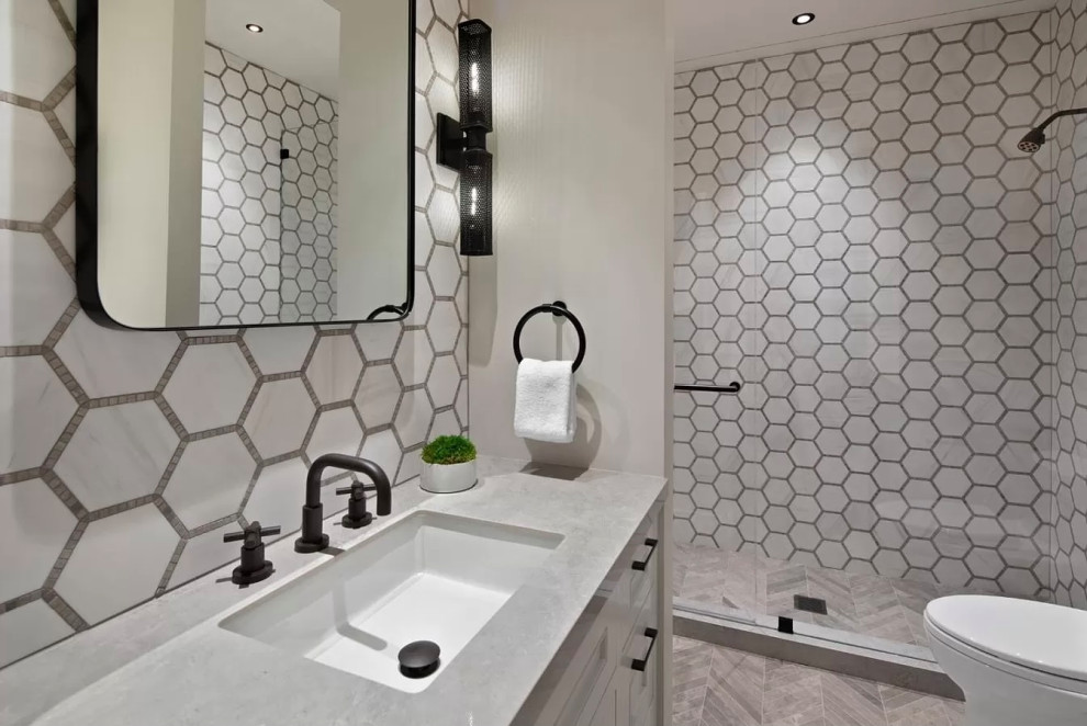 Inspiration for a mid-sized modern master bathroom in Los Angeles with recessed-panel cabinets, white cabinets, a hot tub, a curbless shower, a one-piece toilet, gray tile, cement tile, grey walls, porcelain floors, marble benchtops, grey floor, a sliding shower screen, white benchtops, a single vanity, a floating vanity and coffered.