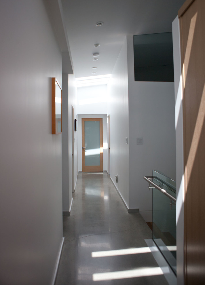 Design ideas for a mid-sized contemporary hallway in Vancouver with white walls and concrete floors.