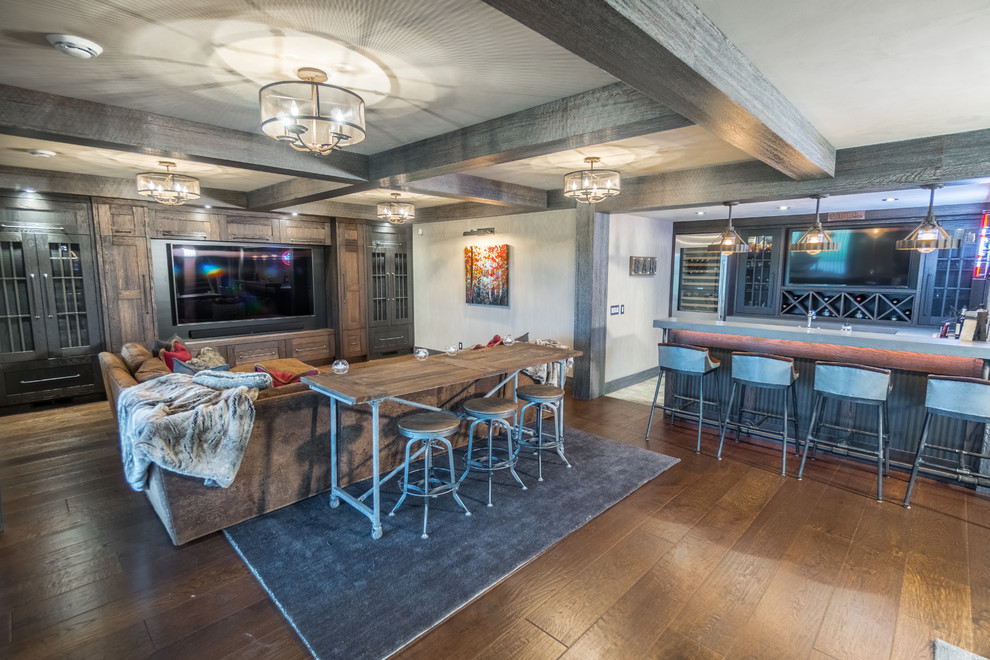 Large mountain style walk-out medium tone wood floor and brown floor basement photo in Calgary with gray walls