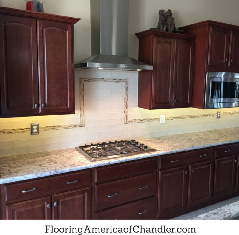 Kitchen - transitional kitchen idea in Phoenix with medium tone wood cabinets, granite countertops, white backsplash, glass tile backsplash and stainless steel appliances