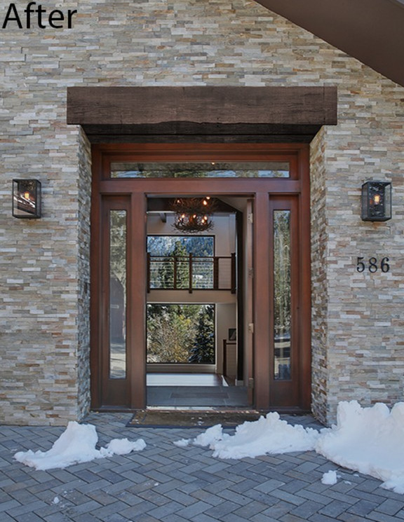 Example of a large mountain style gray floor front door design with a dark wood front door