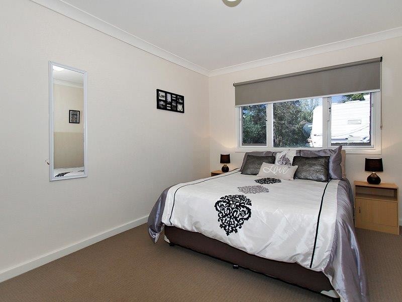 Photo of a small contemporary master bedroom in Perth with white walls, carpet and no fireplace.