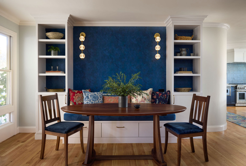 Inspiration for a mid-sized transitional medium tone wood floor, brown floor and wallpaper breakfast nook remodel with blue walls