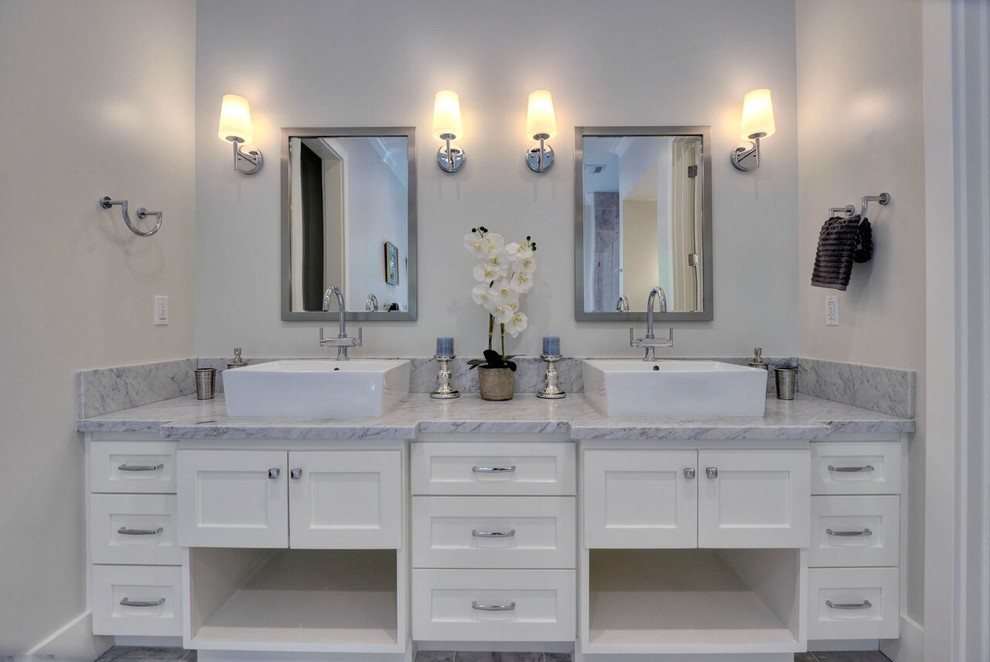 Inspiration for a large transitional master bathroom in San Francisco with shaker cabinets, white cabinets, a freestanding tub, a double shower, gray tile, stone tile, grey walls, marble floors, marble benchtops, a vessel sink and a hinged shower door.