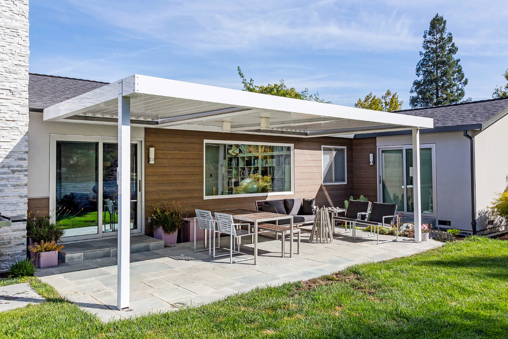 Photo of a mid-sized contemporary backyard screened-in verandah in San Francisco with concrete pavers and an awning.