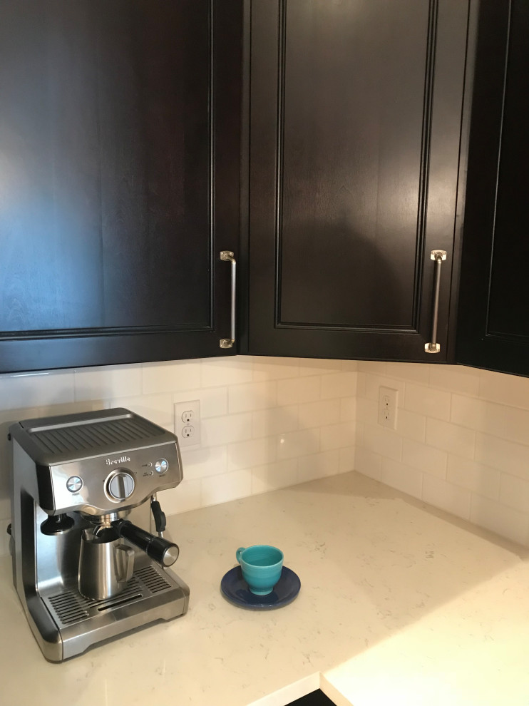 Inspiration for a mid-sized transitional u-shaped eat-in kitchen remodel with a double-bowl sink, shaker cabinets, dark wood cabinets, quartz countertops, white backsplash, subway tile backsplash, stainless steel appliances, no island and white countertops