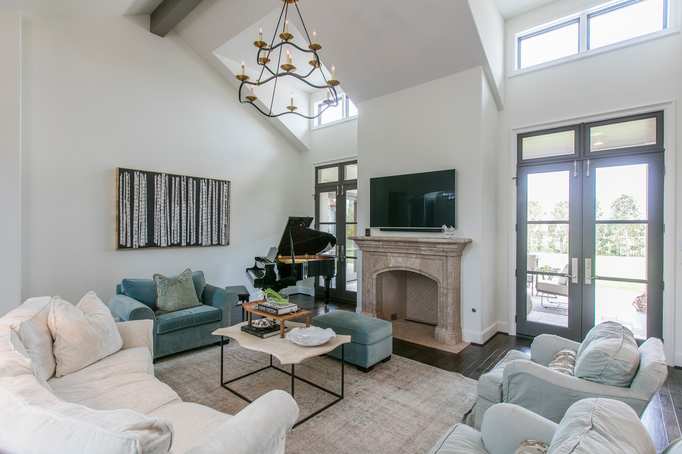Photo of a mid-sized traditional open concept living room in Dallas with white walls, dark hardwood floors, a standard fireplace, a stone fireplace surround and a wall-mounted tv.