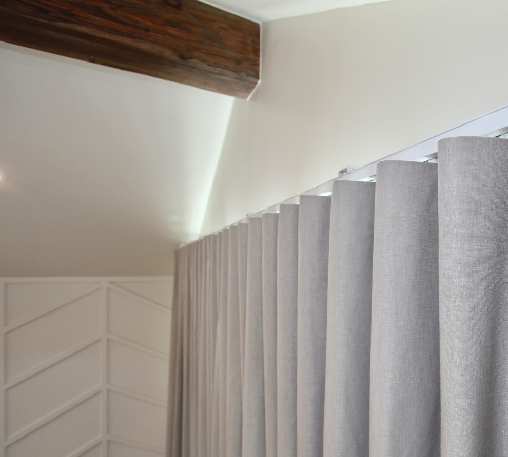 Example of a transitional bedroom design in Denver